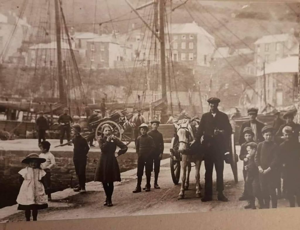 Historic photo of fishermen in Mevagissey harbour Cornwall early 1900s 